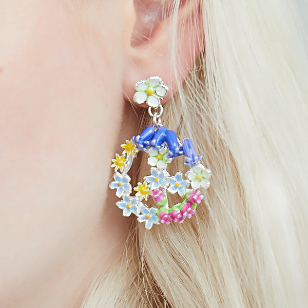 Enamelled Peace Sign earrings by Joy Everley which hang off a Strawberry Flower