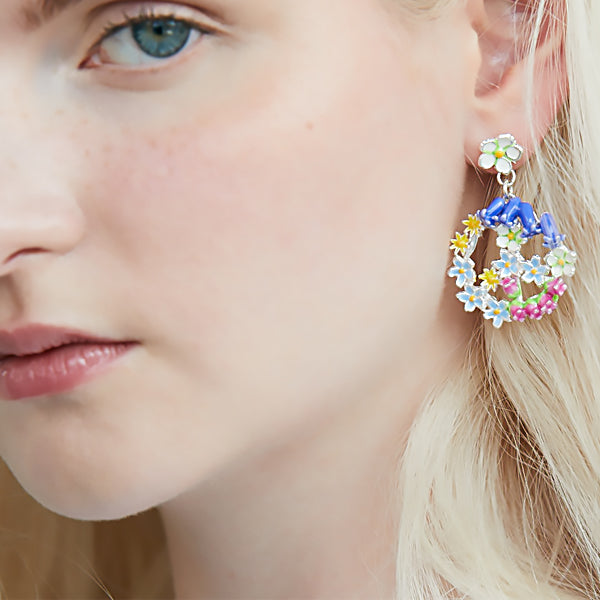 Enamelled Peace Sign earrings by Joy Everley which hang off a Strawberry Flower